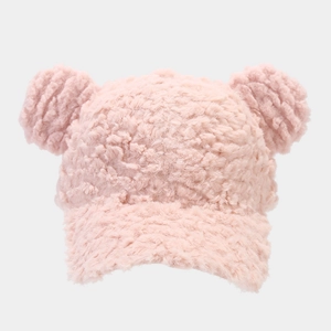 Detail of pink faux fur baseball cap featuring cute round ears and soft lamb wool texture