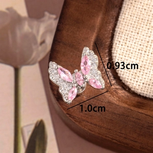 Boucles d'oreilles papillon en argent avec pierres roses, 0,93cm x 1,0cm, sur fond en lin