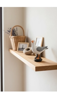 Detail of resin seagull ornament on a wooden shelf with Nordic home decor accents