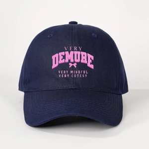 Detail of navy baseball cap featuring pink Very Demure print and bow embroidery