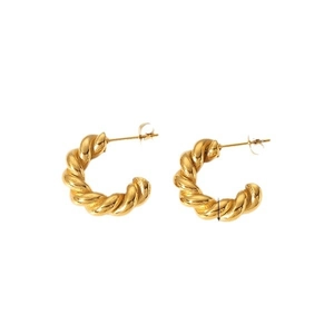 Detail of gold-plated croissant twisted hoop earrings showing refined rope texture