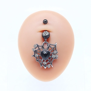 Macro shot of gothic spider web navel ring with black heart zircon on silicone mold