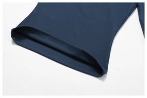 Detail of navy blue athletic top showing reinforced double-stitched hem and matte fabric