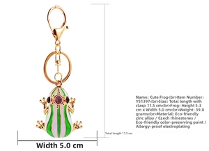 Macro view of gold metal frog keychain with green enamel and purple rhinestones