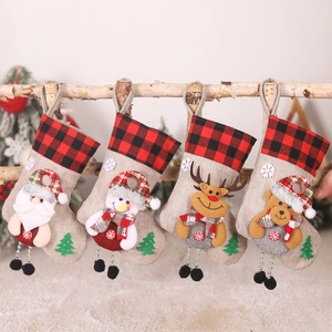 Detailed view of four burlap Christmas stockings with 3D Santa, snowman and elk characters