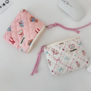 Close-up of quilted floral cotton makeup pouches with cute teddy bear patterns and zip