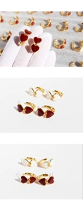 Macro detail of vintage burgundy and cream enamel double heart earrings in gold plating