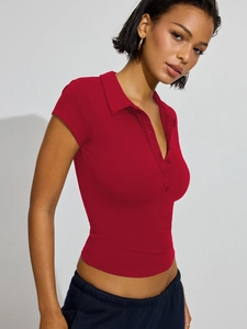 Close-up of a red slim-fit polo shirt featuring a ribbed texture and button-down collar