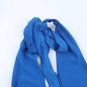 Detailed view of the knotted drawstring on a blue v-neck halter top with textured fabric