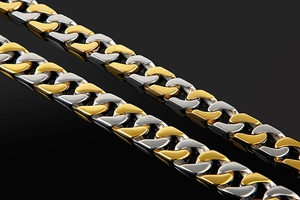 Macro view of gold and silver two-tone stainless steel link chain with metallic luster