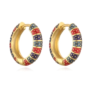 Macro shot of colorful enamel hoop earrings with gold base and vibrant geometric patterns