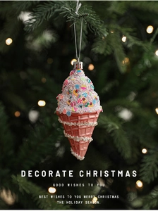Pink ice cream cone Christmas ornament with sprinkles on a festive green tree