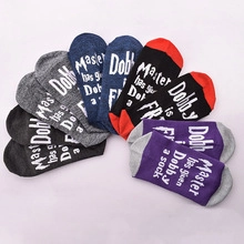Detailed view of six pairs of novelty crew socks with printed slogan on the soles