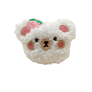 Cute white plush bear brooch with pink embroidery and red strawberry accessory