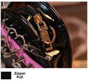 Macro detail of gold zipper pull and silver punk rivets on heart-shaped Y2K bag