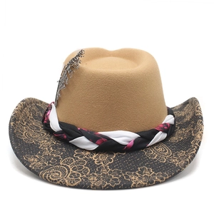 Detail of wide brim felt hat with feather ornament and floral vine patterns on khaki felt