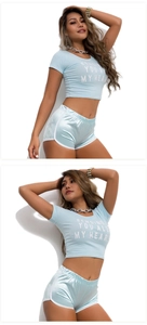 Detail of blue cropped T-shirt with heart text and matching satin hem yoga shorts