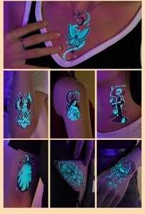Luminous Halloween tattoos featuring blue glowing ghost moon and spider patterns on skin