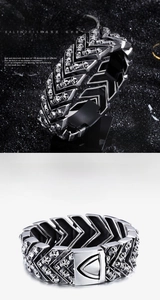 Detailed view of stainless steel punk bracelet with embossed skull charms and V-links