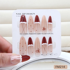 Handmade burgundy and nude almond press-on nails with bow designs and polka dots