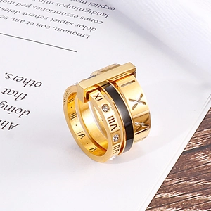 Detail of gold Roman numeral ring with black inlay and sparkling zircon crystals