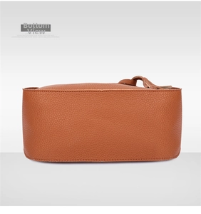 Detail view of the brown lychee pattern leather handbag base with neat stitching
