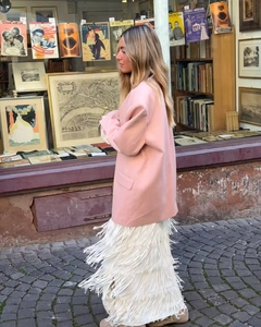 Blazer rosa oversize e gonna con frange catturati in un elegante scatto stile street