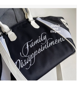 Detail of embroidered lettering and white mesh stitching on black bowling bag