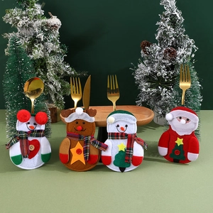 Christmas cutlery holders detail view, festive felt tableware storage bags for table decor.