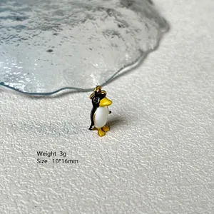 Macro shot of 10x16mm penguin enamel charm with dimensions and 3g weight details