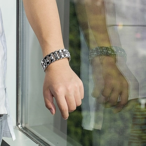 Close-up of polished punk style skull bracelet with clear zircons on male wrist