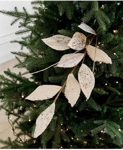 Macro detail of champagne gold glitter velvet leaves for Christmas tree decoration