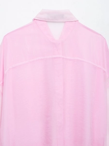 Dettaglio degli inserti in organza rosa su questa camicia lunga elegante con cintura in vita