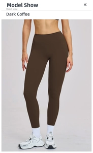 Deep coffee high-waisted yoga pants shown with white sneakers in a professional studio view