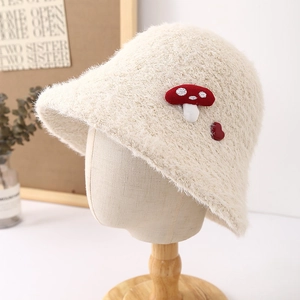 Cream knit fuzzy bucket hat with cute mushroom patches for warm winter styling