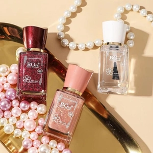 Three bottles of BGve 14ml nail polish in red glitter and pink shades on gold tray