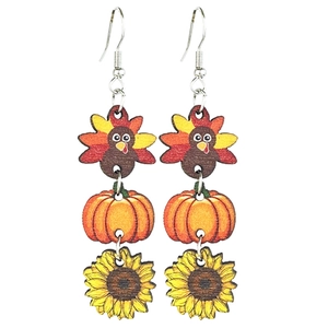 Thanksgiving wooden drop earrings with turkey pumpkin and sunflower motifs on white backdrop