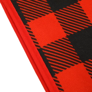 Detail of red and black buffalo plaid fabric with precise stitched edging decoration