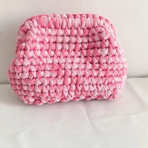Close-up of pink crochet cloud bag with detailed woven texture and coquette label