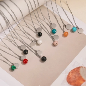 Macro detail of various colorful natural stone beads and round metal pendants on necklaces