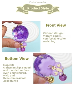 Detailed view of creative purple oil-filled wind chime keychain with dried flowers