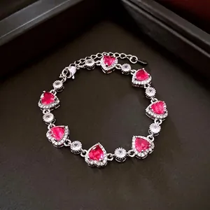 Silver bracelet featuring seven pink heart zircon stones with micro-pavé halos and clasp