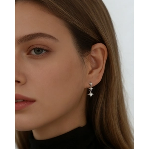 Gros plan de boucles d'oreilles étoiles en argent S925 avec zircons sur un mannequin