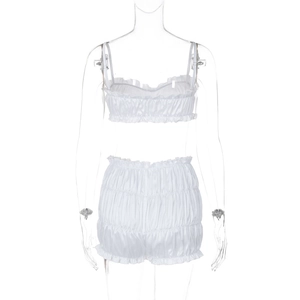 Detail of white two-piece set featuring ruffled bandeau top and frill hem shorts