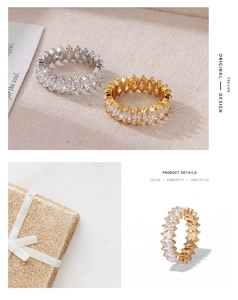 Detailed view of marquise-cut zircon rings in gold and silver with elegant gift box packaging