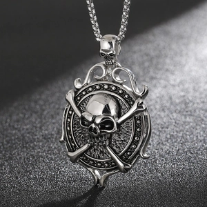 Detailed macro view of punk stainless steel skull and crossbones pendant on box chain
