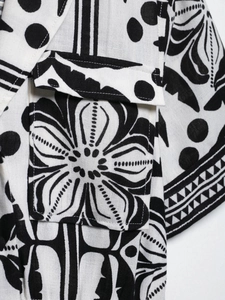 Detailed macro view of black and white ethnic floral print on linen texture fabric