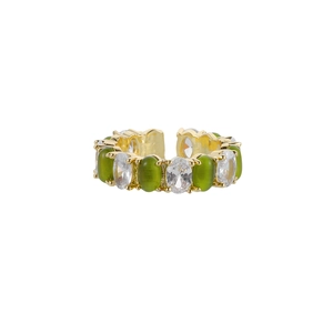 Detail of gold open ring featuring alternating green and clear oval zircon stones