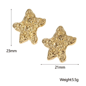 Detailed view of 23mm gold star earrings with unique hammered metal texture finish