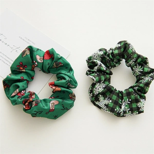 Close-up of green Christmas scrunchies with festive socks and snowflake patterns